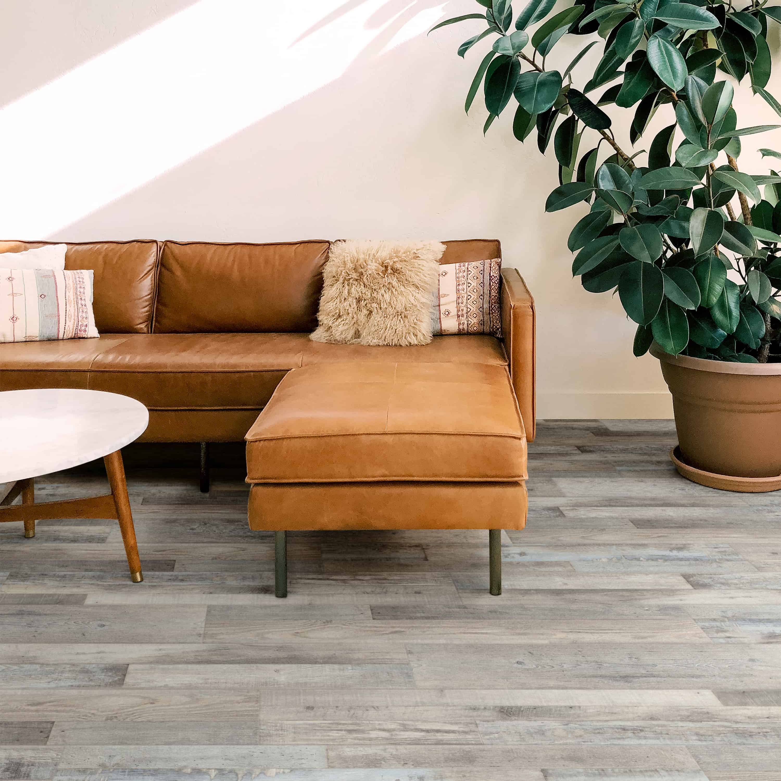 Glue-down luxury vinyl plank floor in weathered grey bonded to the subfloor