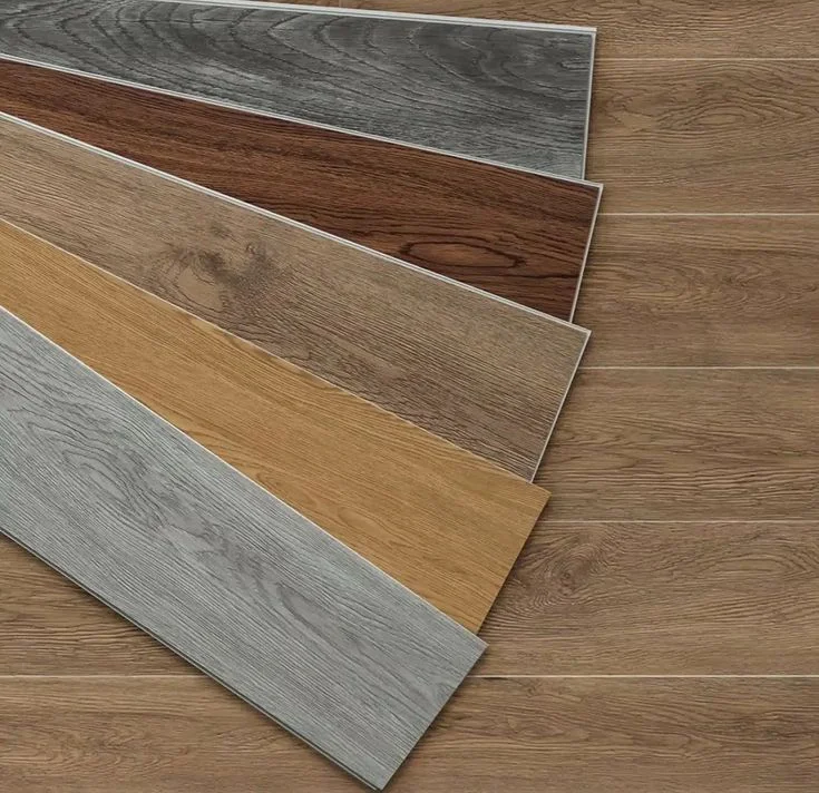 Fanned selection of luxury vinyl plank samples in grey, walnut and oak tones